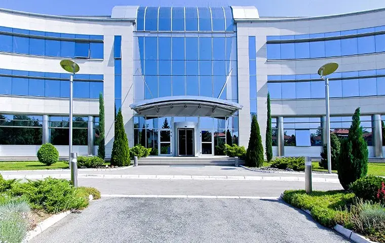 Large commercial building exterior, showcasing a broad, modern structure.